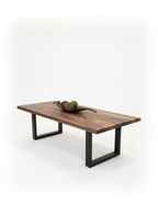 Wooden coffee table with black metal legs on a white background